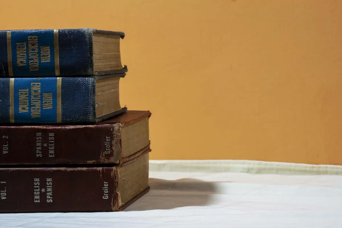 A translator&rsquo;s desk with dictionaries and foreign language books